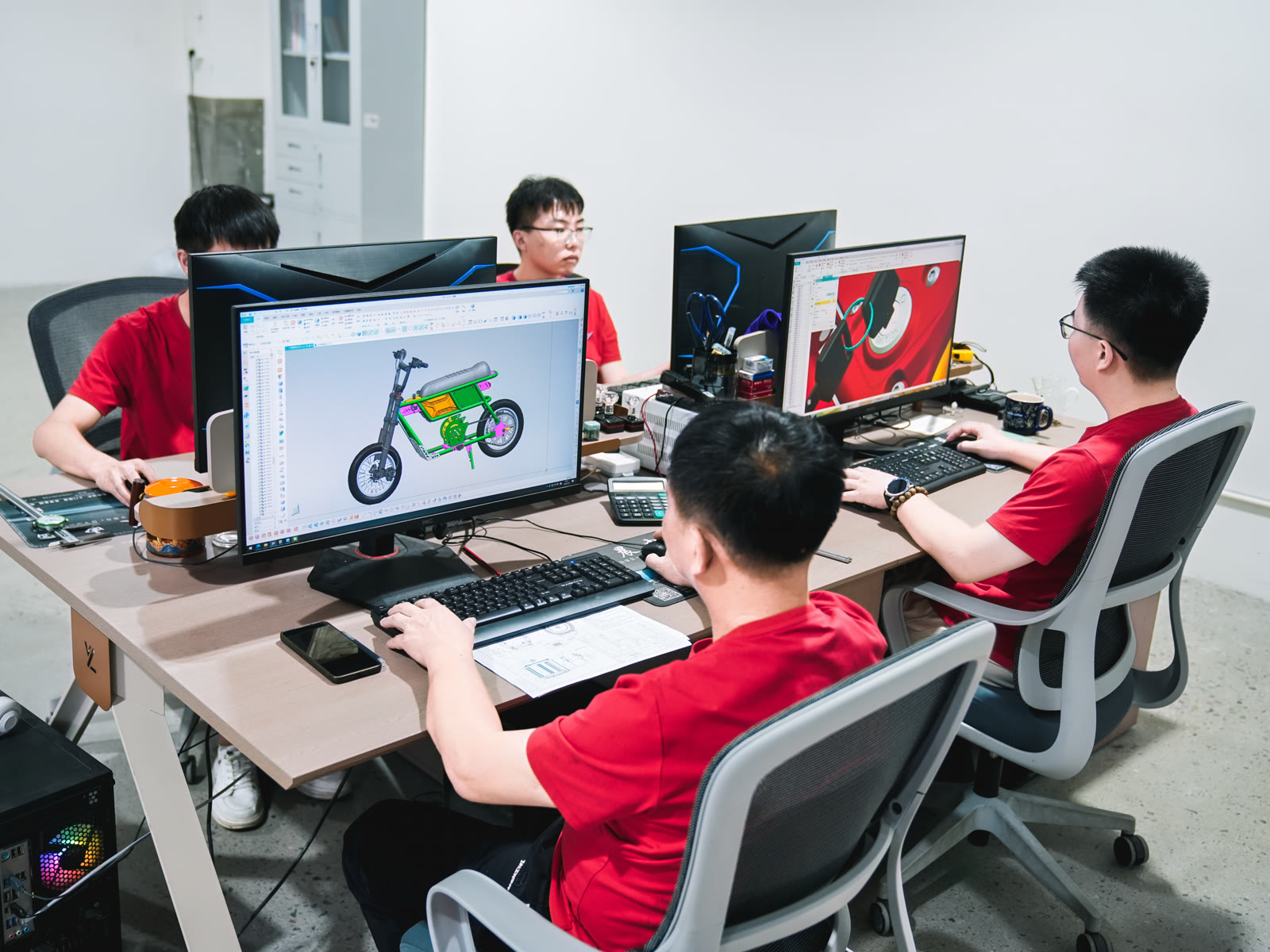 ARKAMOTO engineers working on a motorcycle CAD design